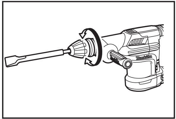 User wearing safety gear while operating a demolition hammer on tiles